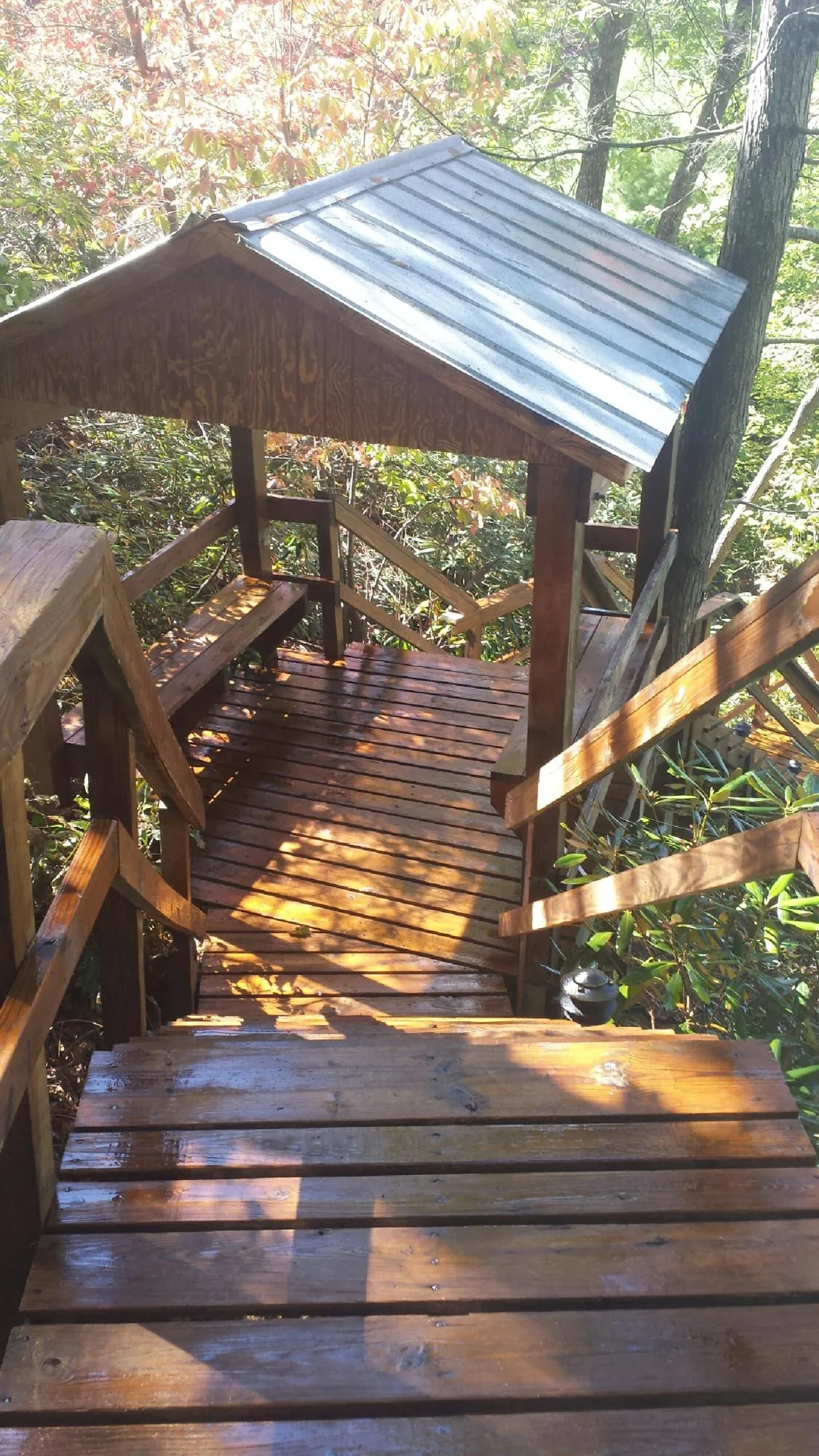 Freshly stained wood walkway and covered shelter with a metal roof in Pleasantville